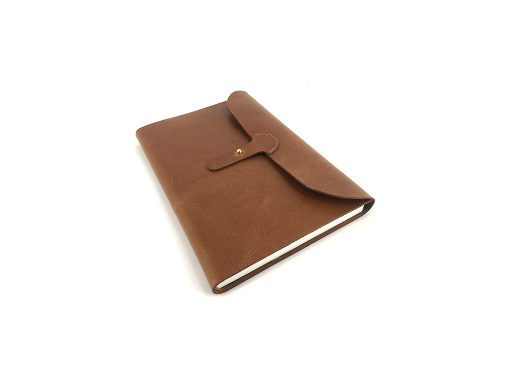 Leather journal with pin closure 
Size 6 X 8.5 inch with mill made paper